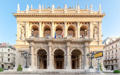 Hungarian State Opera exterior with ornate columns and statues, Budapest.