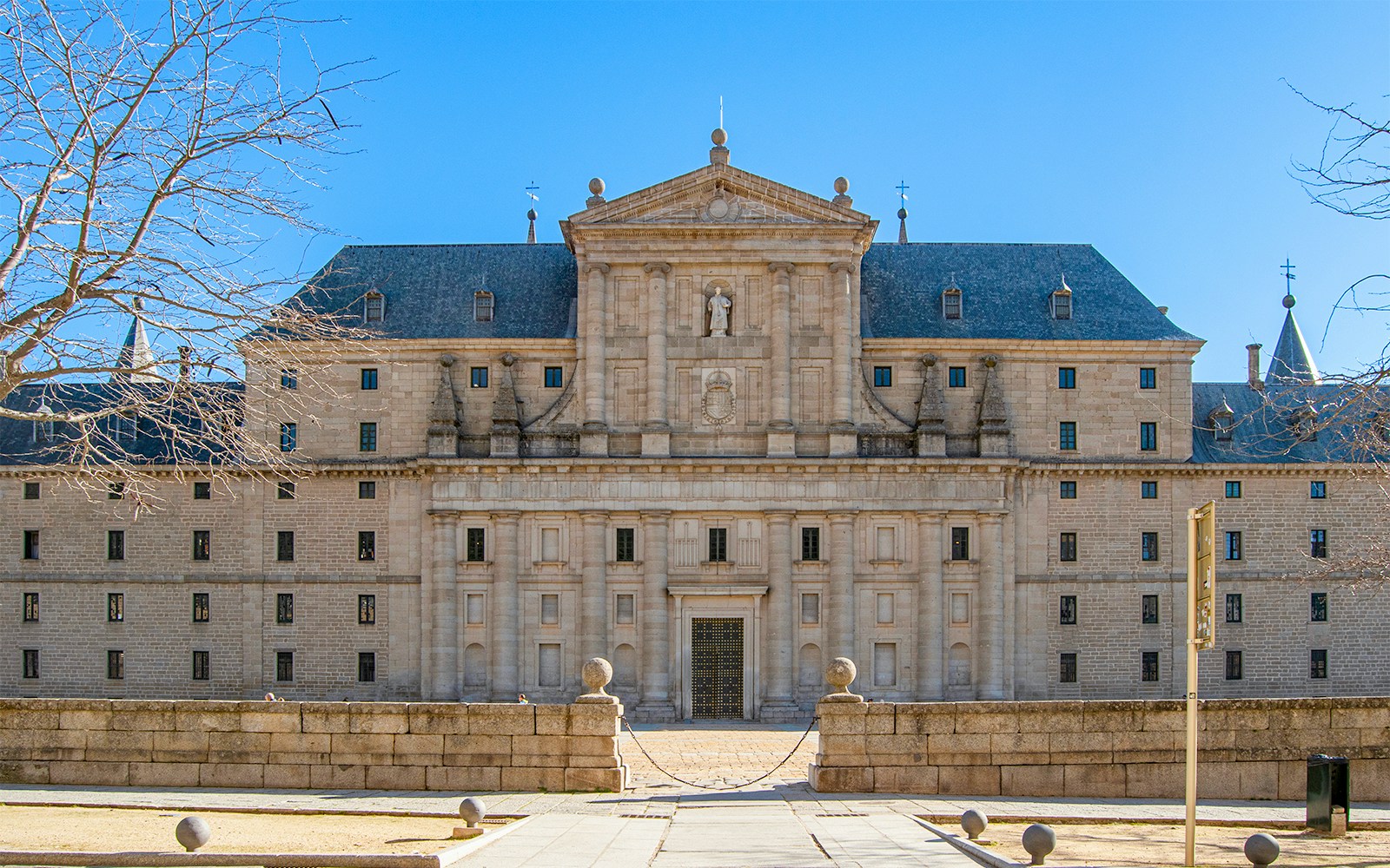 Main facade of San Lorenzo del Escorial monastery, Madrid, Spain, showcasing its architectural grandeur.