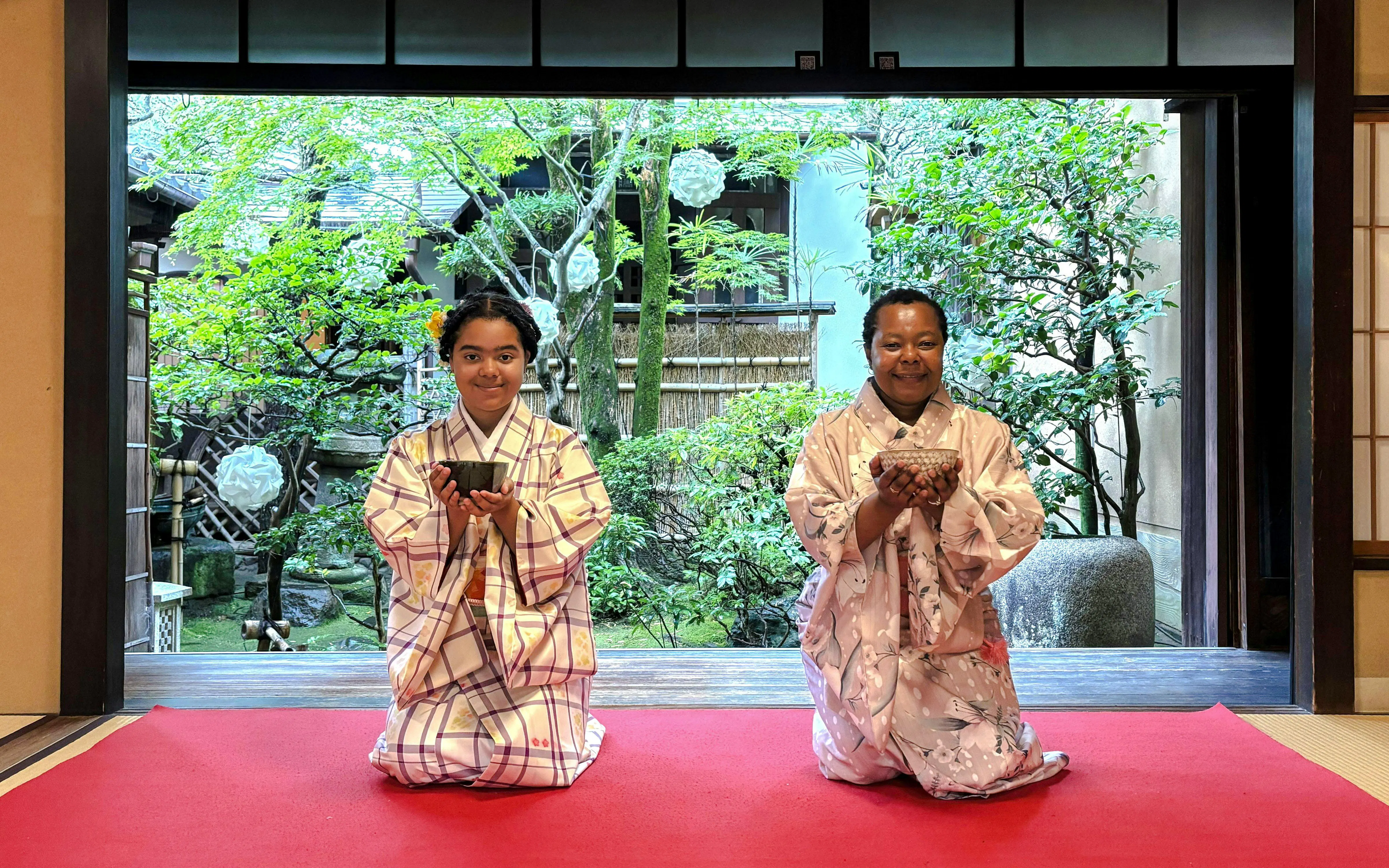 Guests in traditional kimonos participating in a tea ceremony in Kyoto, Japan.