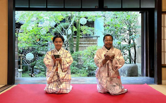 Guests in traditional kimonos participating in a tea ceremony in Kyoto, Japan.