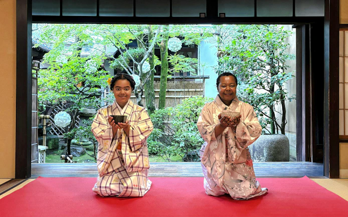 Guests in traditional kimonos participating in a tea ceremony in Kyoto, Japan.