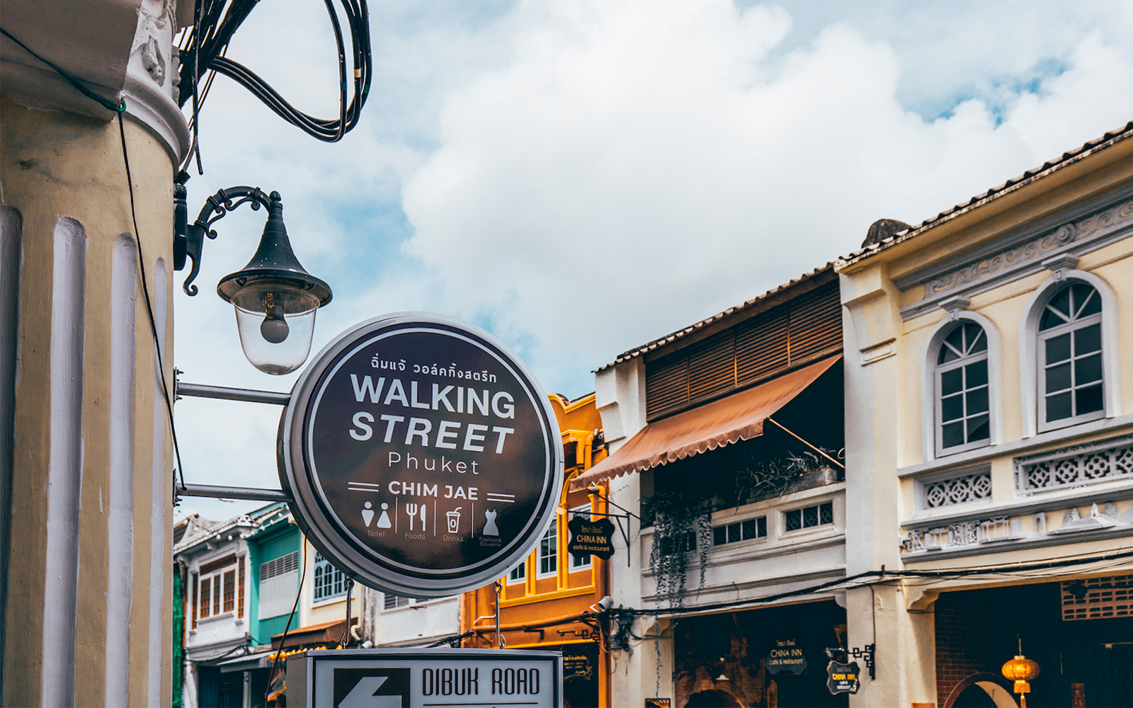Walking Street sign and colorful buildings in Phuket, Thailand.