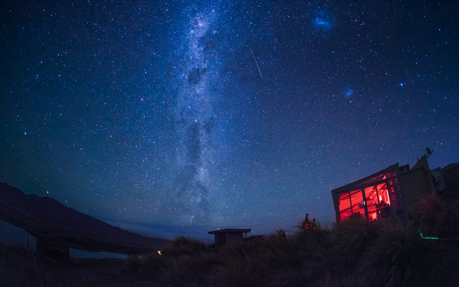 Stargazing at Mt. John Observatory under a starry sky with visible Milky Way.