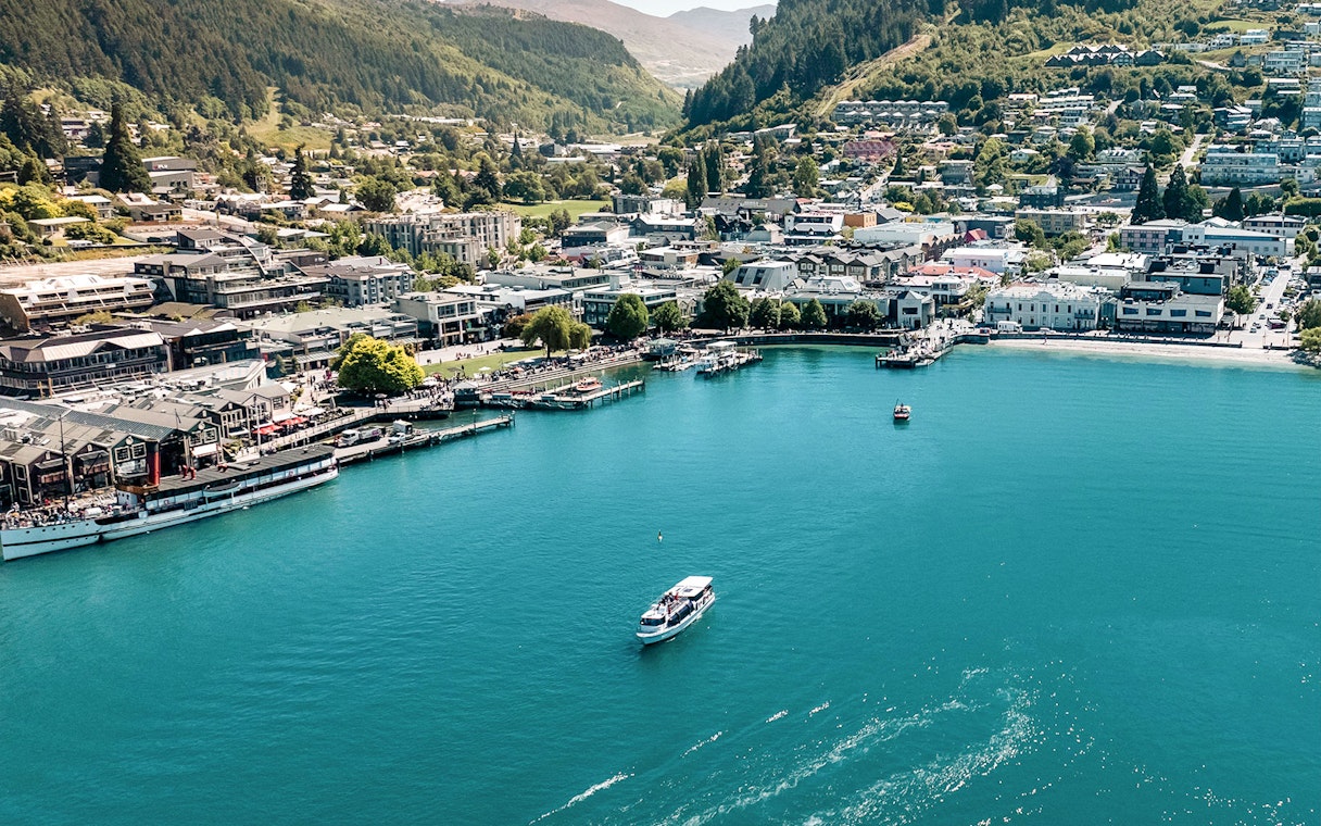 Aerial view of Million Dollar Cruise boat on Lake Wakatipu near Queenstown waterfront.