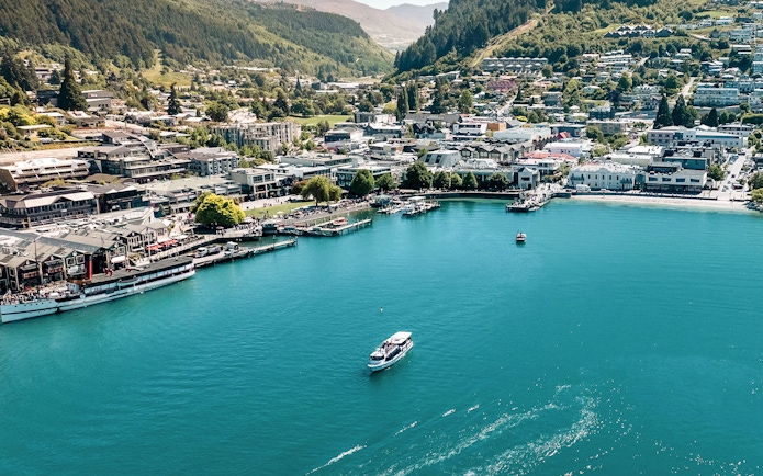 Aerial view of Million Dollar Cruise boat on Lake Wakatipu near Queenstown waterfront.