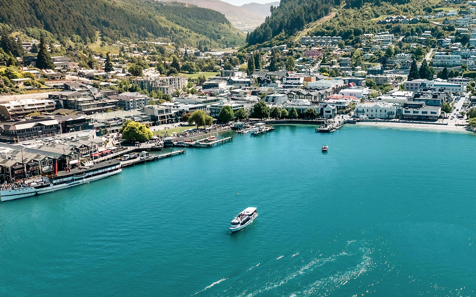 Aerial view of Million Dollar Cruise boat on Lake Wakatipu near Queenstown waterfront.