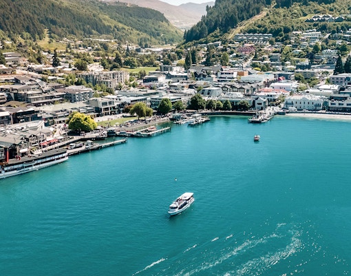 Aerial view of Million Dollar Cruise boat on Lake Wakatipu near Queenstown waterfront.