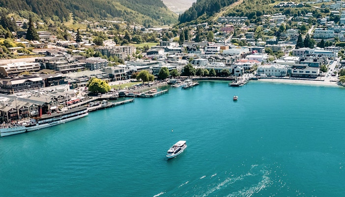 Aerial view of Million Dollar Cruise boat on Lake Wakatipu near Queenstown waterfront.