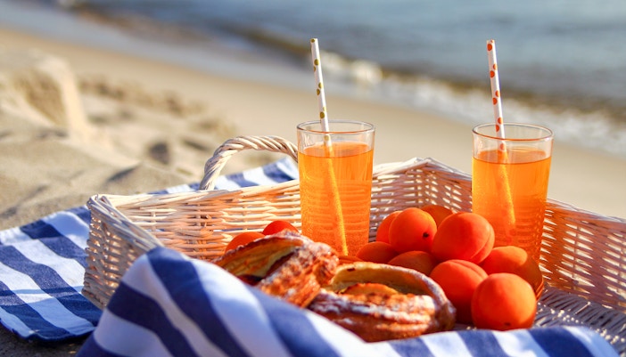 Picnic setup with drinks and fruit on Moreton Island beach.