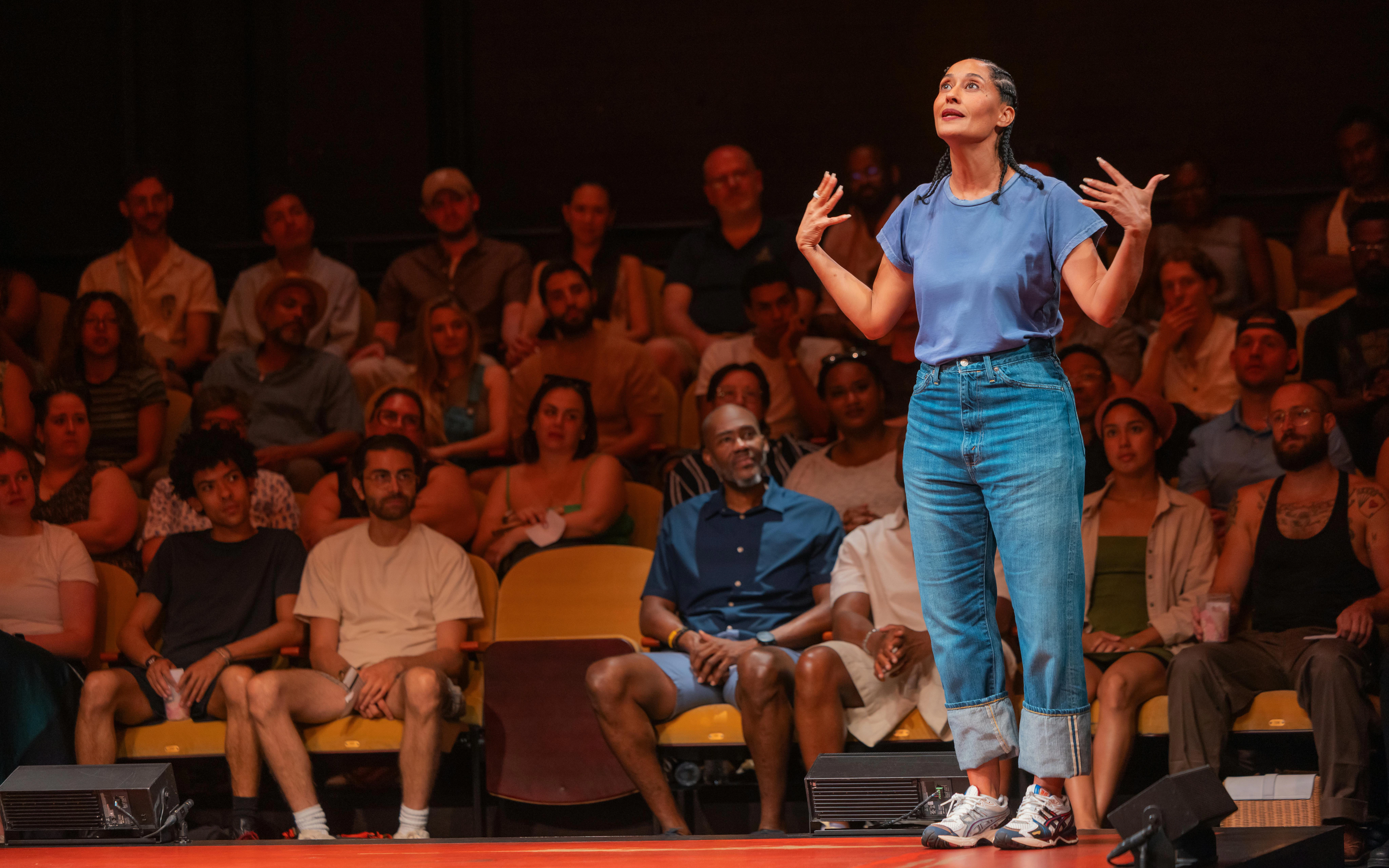 Performer on stage during Every Brilliant Thing, Broadway, with audience in background.