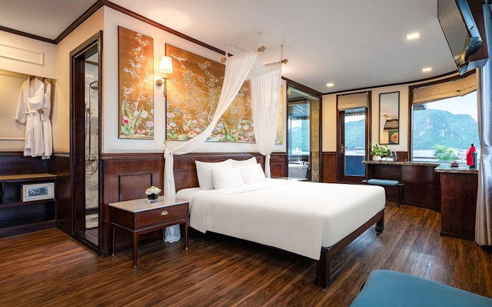 Royal Suite bedroom with elegant decor and scenic view on Amanda Luxury Cruise.