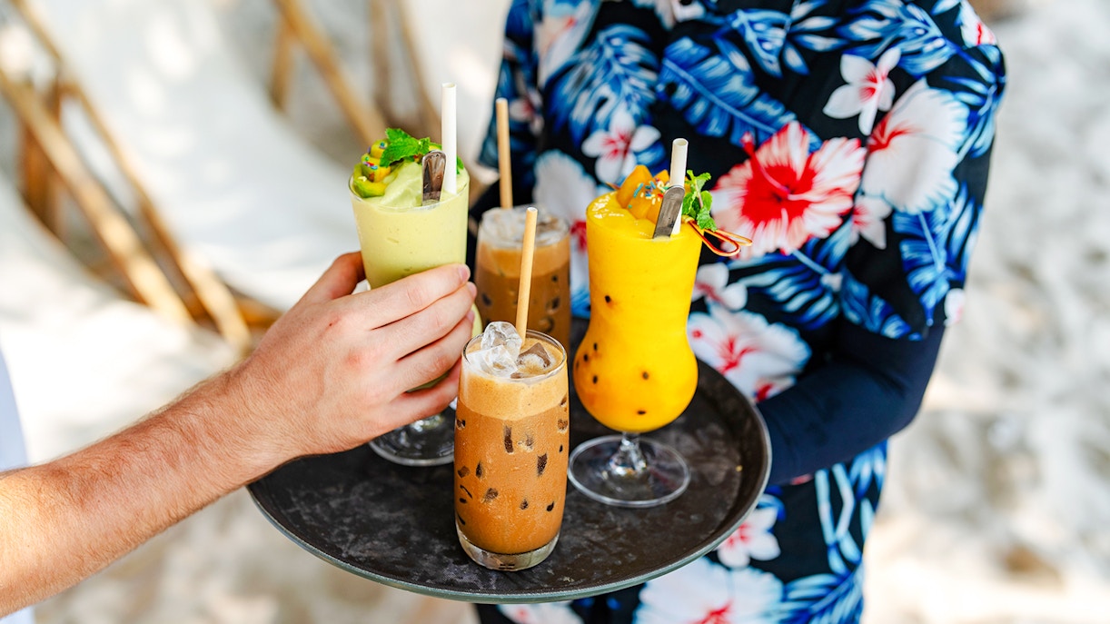 Beachside drinks being served on a tray at Cap d’Ail.
