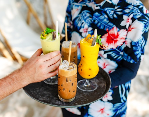 Beachside drinks being served on a tray at Cap d’Ail.
