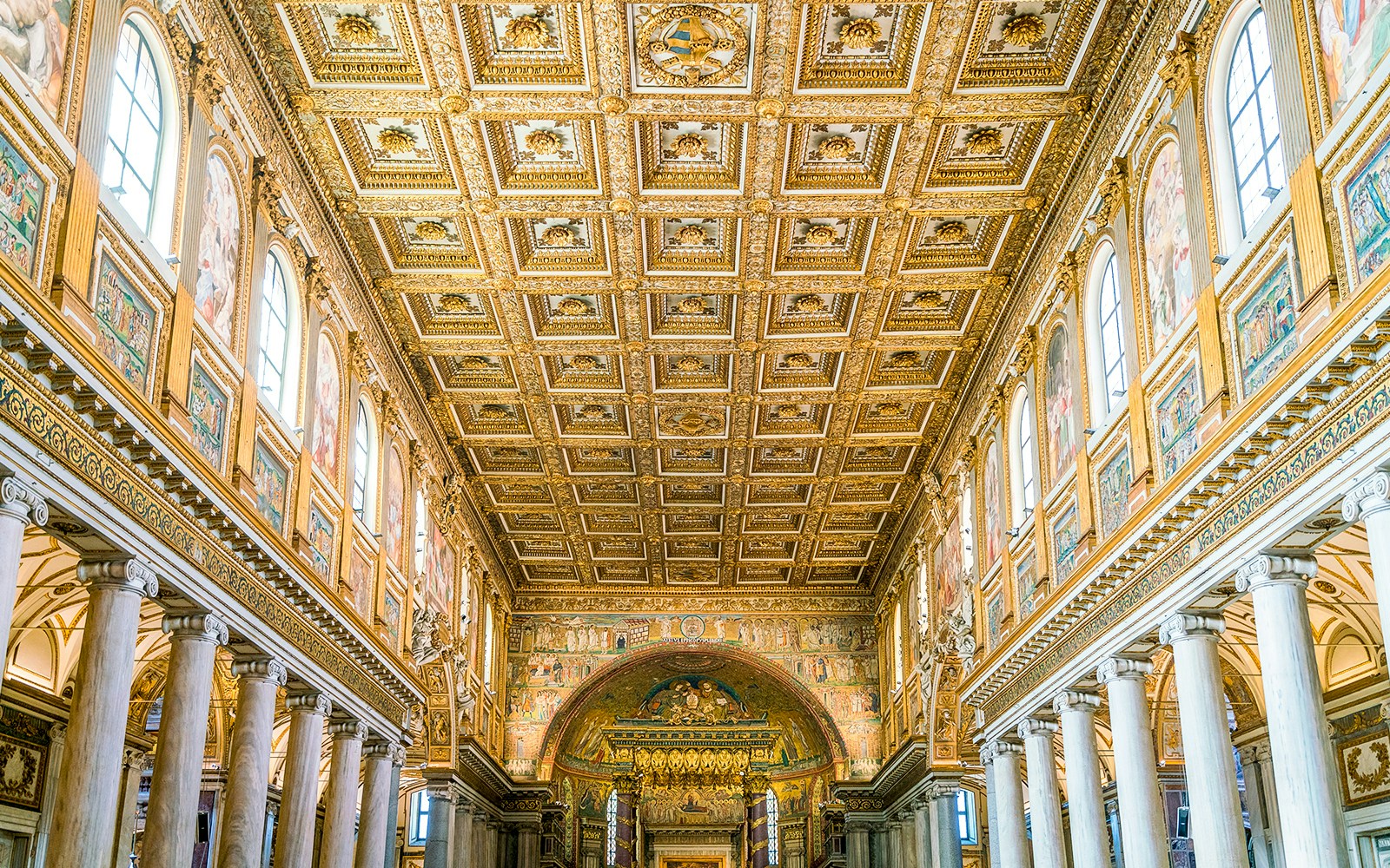 Interiors of the Basilica of Santa Maria Maggiore in Rome, showcasing ornate ceilings and detailed mosaics.
