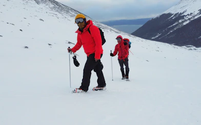 Tourists hiking on Ushuaia Martial Glacier with snow gear.