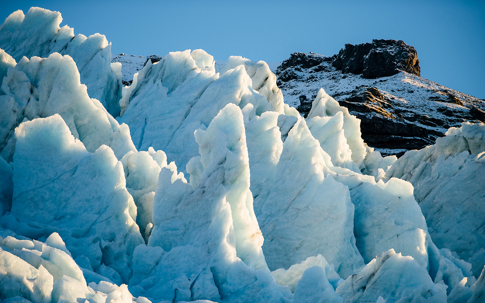 Vatnajökull Ice Cap with jagged ice formations under clear sky.