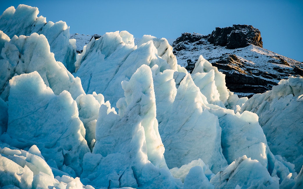 Vatnajökull Ice Cap with jagged ice formations under clear sky.