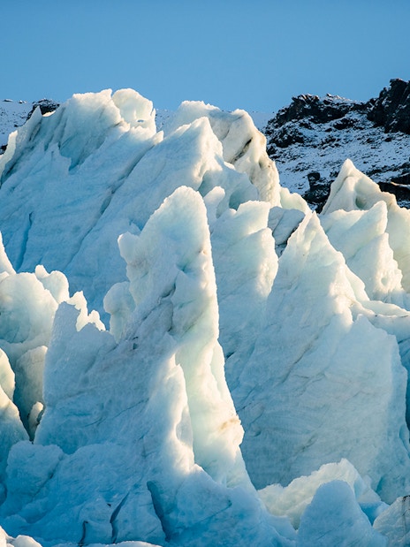 Vatnajökull Ice Cap with jagged ice formations under clear sky.