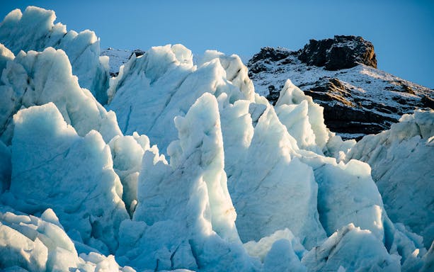 Vatnajökull Ice Cap with jagged ice formations under clear sky.