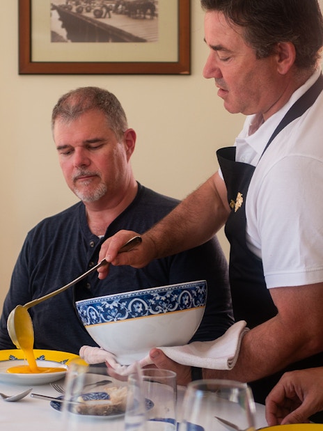 Tourist being served soup during lunch on Douro Valley Full-Day Tour.