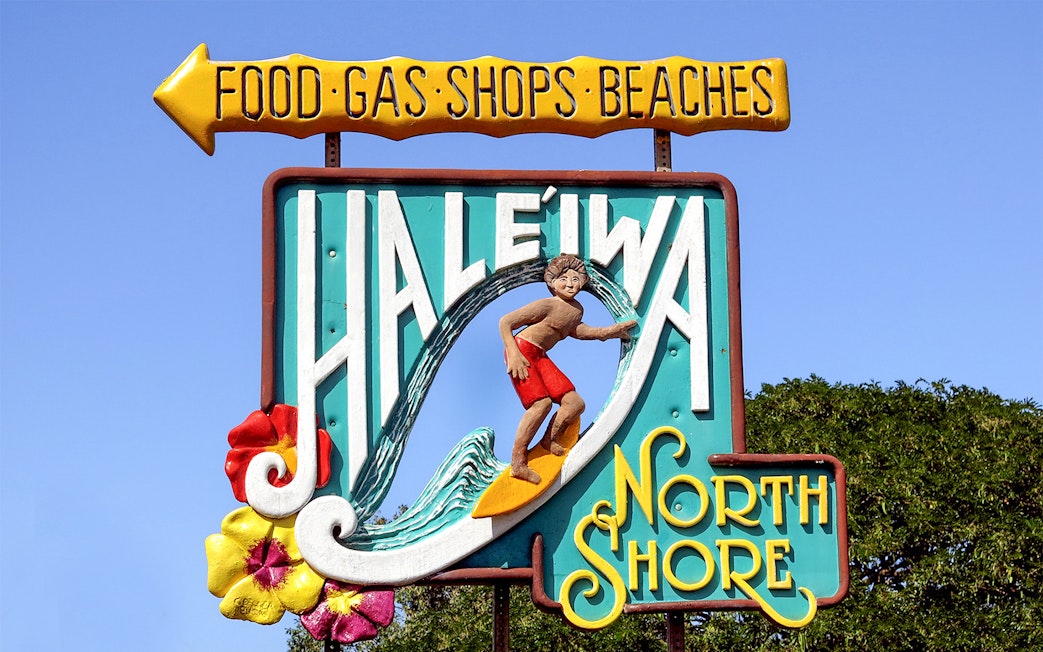 Haleiwa Town sign with surfer and North Shore text, Oahu, Hawaii.