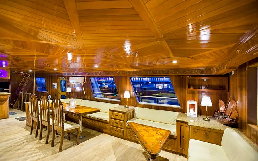 Indoor deck of Amelia Rose yacht with seating and dining area for Whale Watching Cruise, Reykjavík.