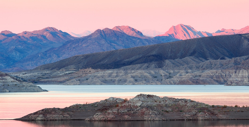 Sunset over Lake Mead with distant mountain range, Nevada, USA.