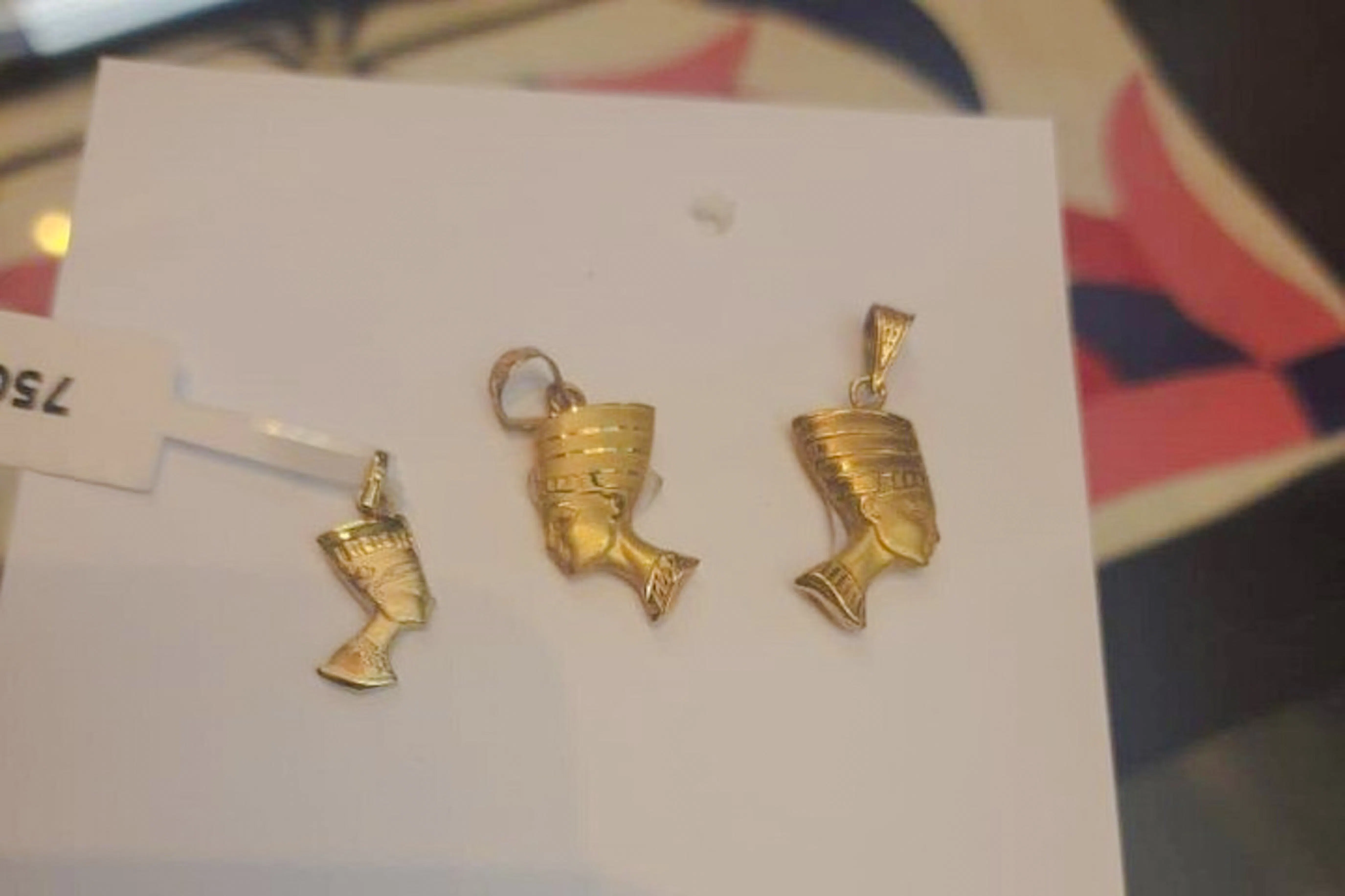 Gold Nefertiti pendants on display, Khan el-Khalili market, Cairo.
