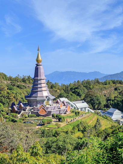 Noppamethanedon and Nopphonphusiri pagodas on Kew Mae Pan trail, Doi Inthanon, surrounded by lush greenery.
