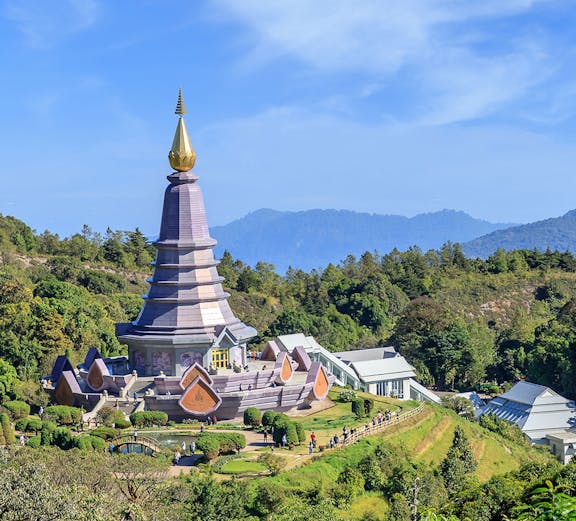 Noppamethanedon and Nopphonphusiri pagodas on Kew Mae Pan trail, Doi Inthanon, surrounded by lush greenery.