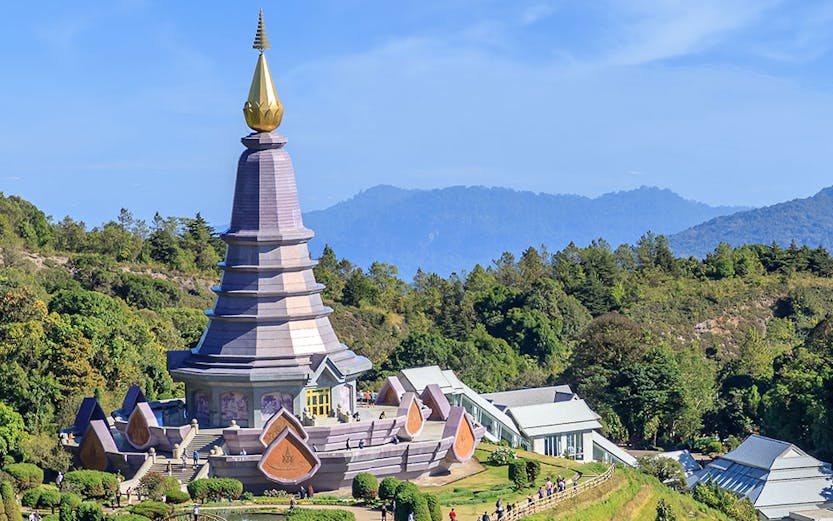 Noppamethanedon and Nopphonphusiri pagodas on Kew Mae Pan trail, Doi Inthanon, surrounded by lush greenery.