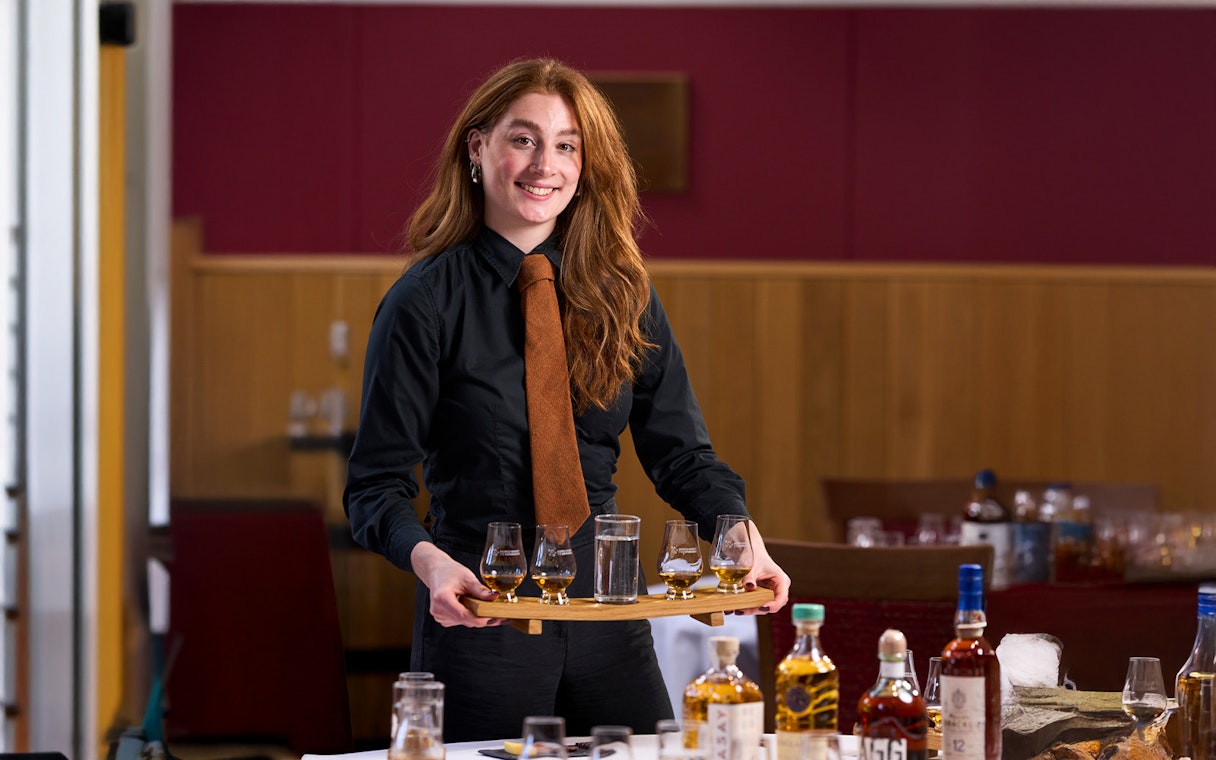 Host presenting whisky samples at the Scotch Whisky Experience.