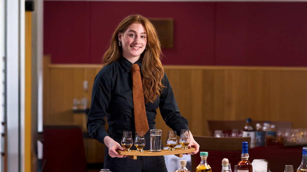 Host presenting whisky samples at the Scotch Whisky Experience.