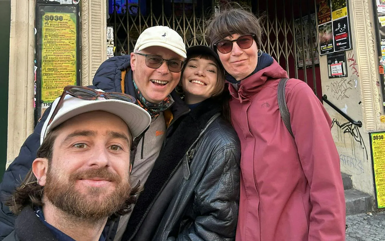 Group of people smiling outside a venue in Berlin Kreuzberg, part of the self-guided city exploration game.