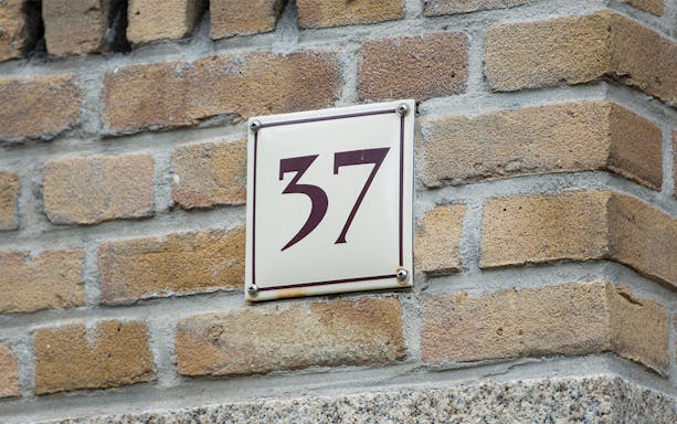 House number 37 on brick wall, Amsterdam.