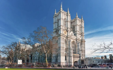 Westminster Abbey with afternoon tea bus passing in London.