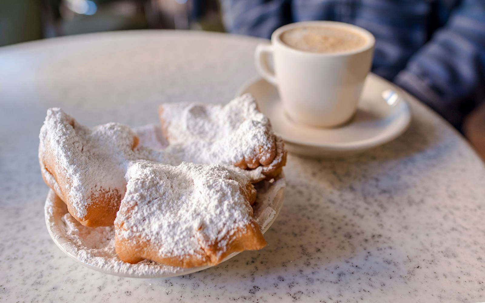 Beignets with powdered sugar at Cafe Du Monde, French Quarter, New Orleans.