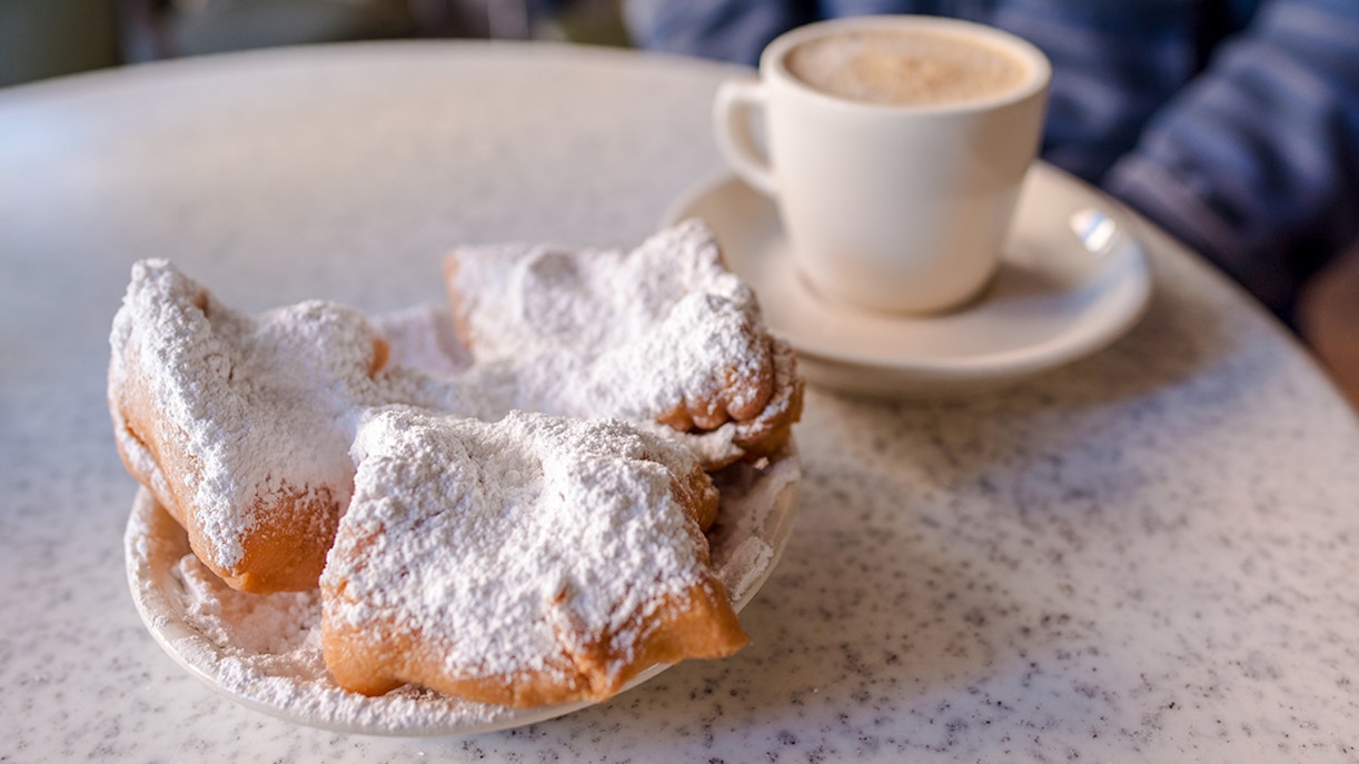 Beignets with powdered sugar at Cafe Du Monde, French Quarter, New Orleans.