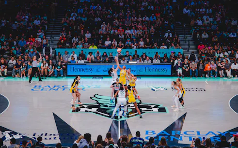 Players at center court during a basketball game at Barclays Center, New York Liberty.