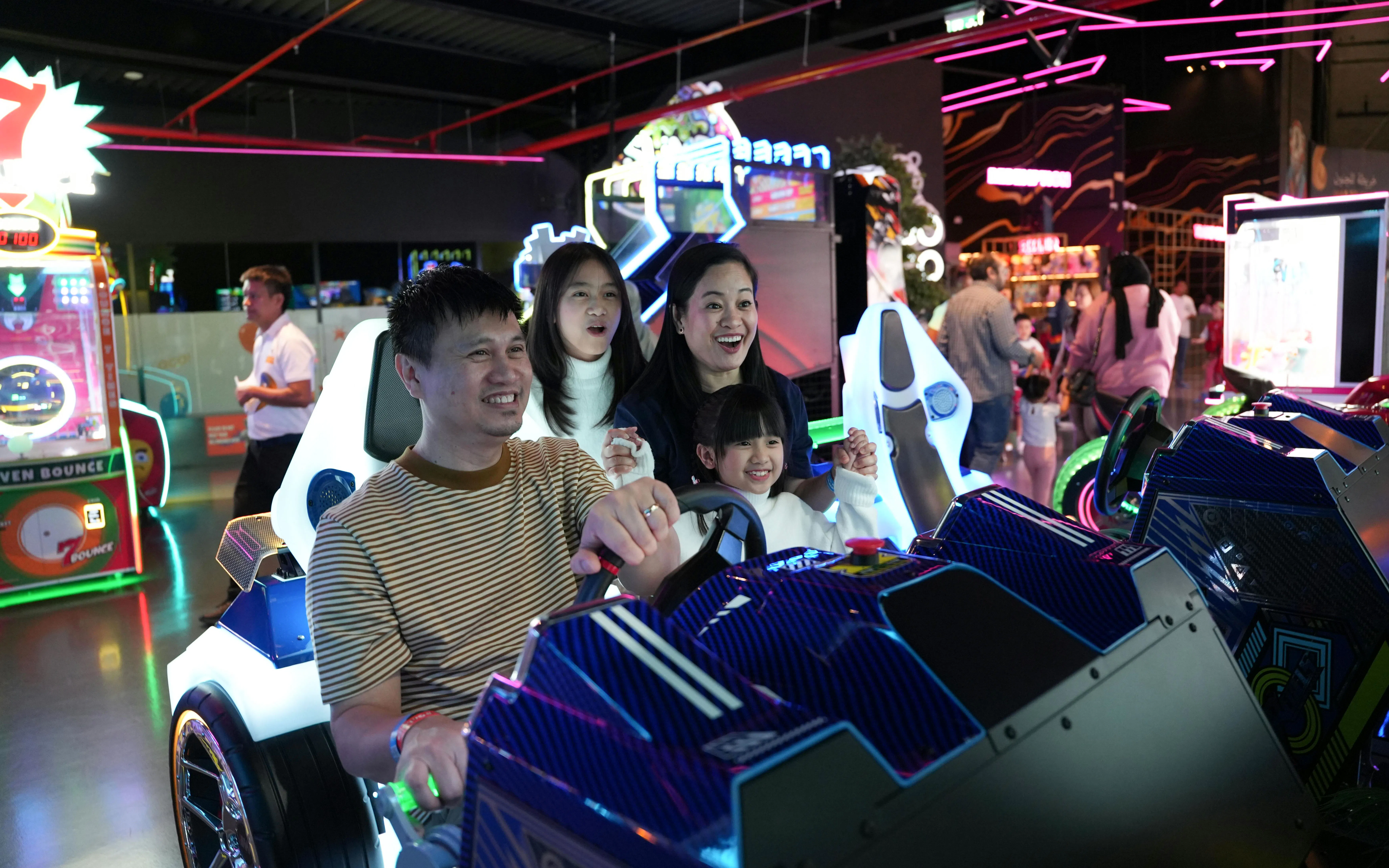 Family enjoying arcade racing game at Loco Bear, Dubai.