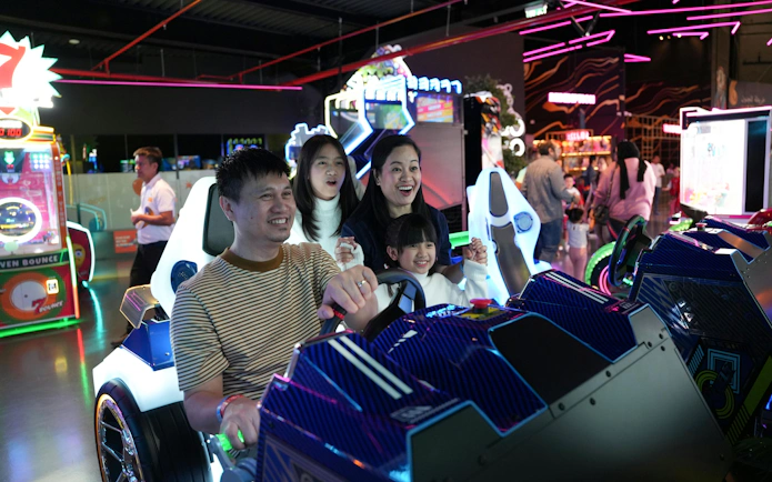 Family enjoying arcade racing game at Loco Bear, Dubai.
