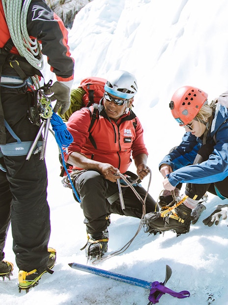 Climbers preparing gear for Fox Glacier heli ice climbing experience in New Zealand.