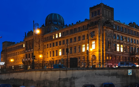 Ministry of Industry and Trade building illuminated at night by the Vltava River, Prague.