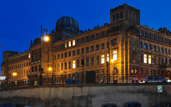 Ministry of Industry and Trade building illuminated at night by the Vltava River, Prague.
