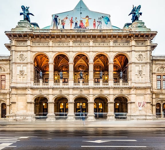 Vienna State Opera facade with arches and statues, Austria.