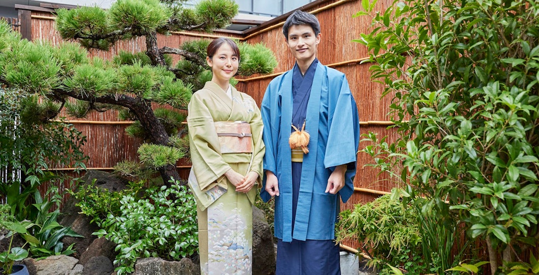 Couple in colorful kimonos at Tokyo Maikoya Tea Ceremony garden, Japan.