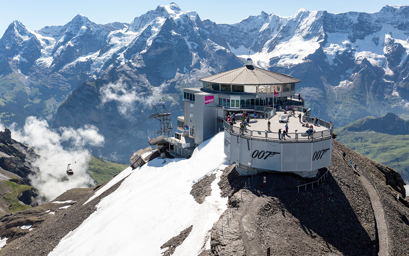 Schilthorn summit with Piz Gloria restaurant and Swiss Alps, accessible via Swiss Travel Pass Flex.