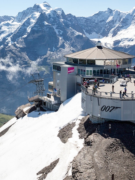 Schilthorn summit with Piz Gloria restaurant and Swiss Alps, accessible via Swiss Travel Pass Flex.
