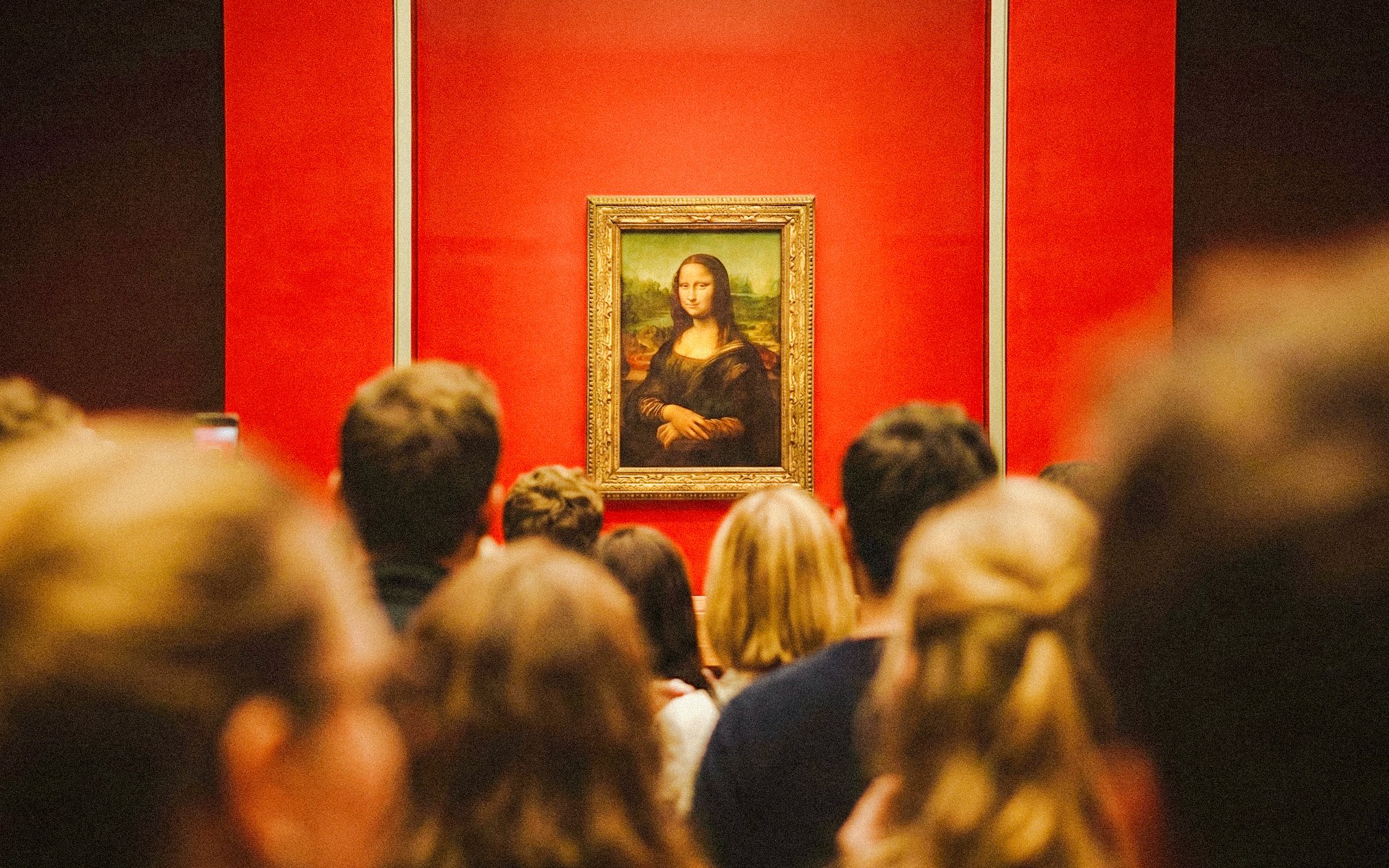 Tourists viewing the Mona Lisa at the Louvre Museum, Paris, France.