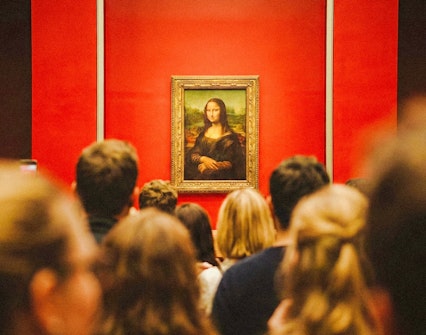 Tourists viewing the Mona Lisa at the Louvre Museum, Paris, France.